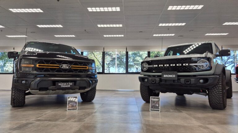 Vista frontal de las camionetas Ford F-150 Tremor y Ford Bronco exhibidas en un showroom, reconocidas por los Premios Autocosmos como los mejores vehículos del año en sus categorías