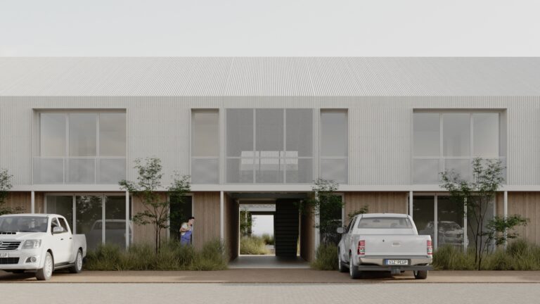 Fachada moderna de viviendas con camionetas estacionadas, parte del desarrollo inmobiliario Nativa Housing en Añelo