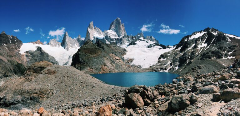 Paisaje de El Chaltén con laguna y montañas nevadas bajo un cielo despejado, representando los destinos naturales más elegidos del turismo argentino para el verano 2026