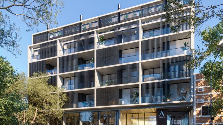 Edificio residencial moderno de arquitectura minimalista en Villa Devoto con líneas rectas balcones amplios y vegetación urbana